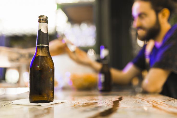 Photo of an alcohol bottle sitting on a bar
