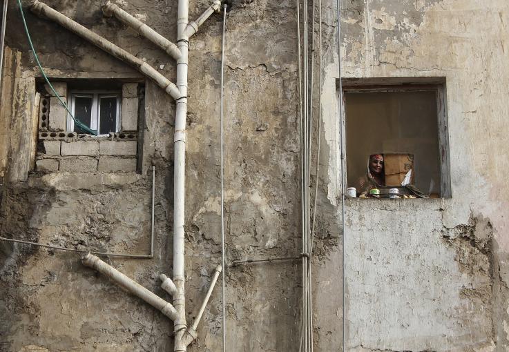 Photo of a mother watching children play in Aden, Yemen