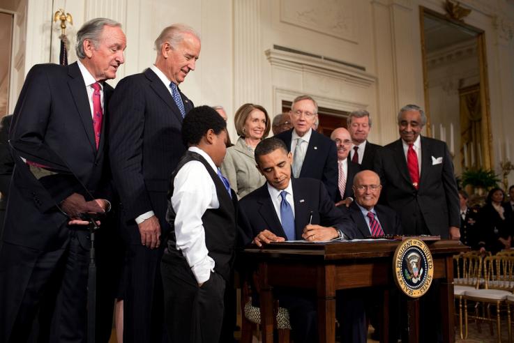 Photo of former President Barack Obama signing the Affordable Care Act