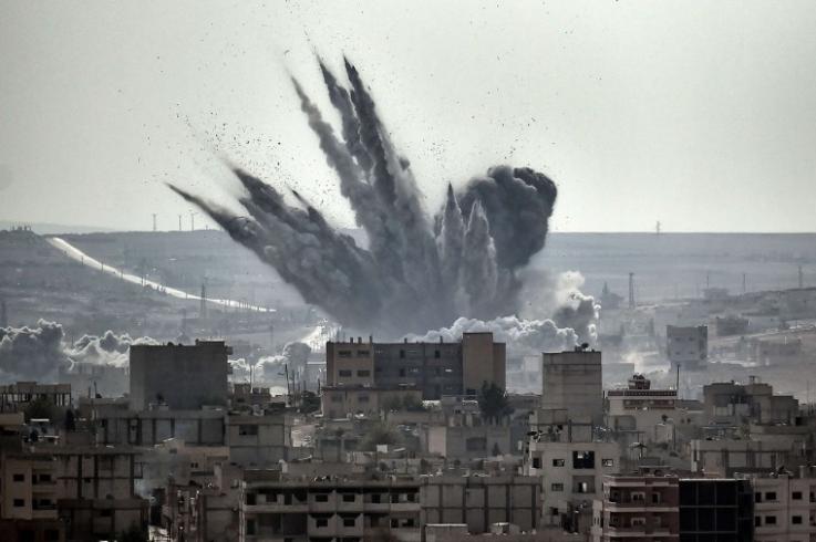 shell explodes in Kobane, Syria Photo of a shell exploding in Kobane, Syria