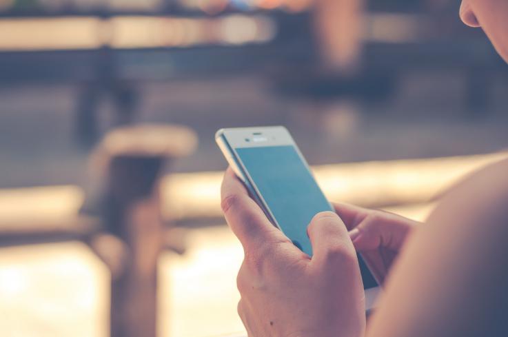 Photo of a woman holding a cell phone