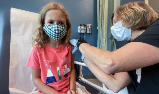 Lydia Melo, 7, gets the first of two Pfizer Covid-19 vaccines during a clinical trial at Duke University in Durham, N.C., on Sept. 28, 2021.Shawn Rocco / Duke Health