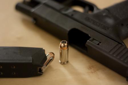 Photo of a handgun and bullets