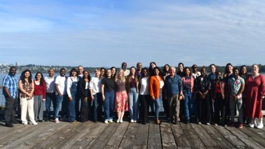 Group photo of START retreat attendees standing on a dock.