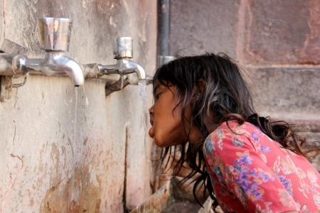 Photo of a child drinking water in India