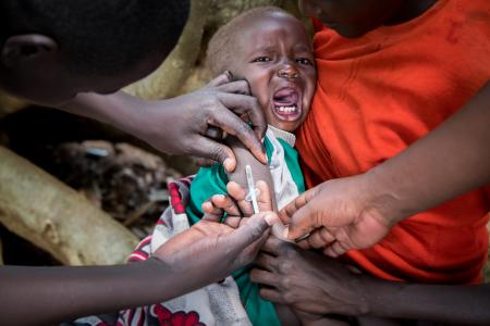 A child recieves a vaccine in Kenya.