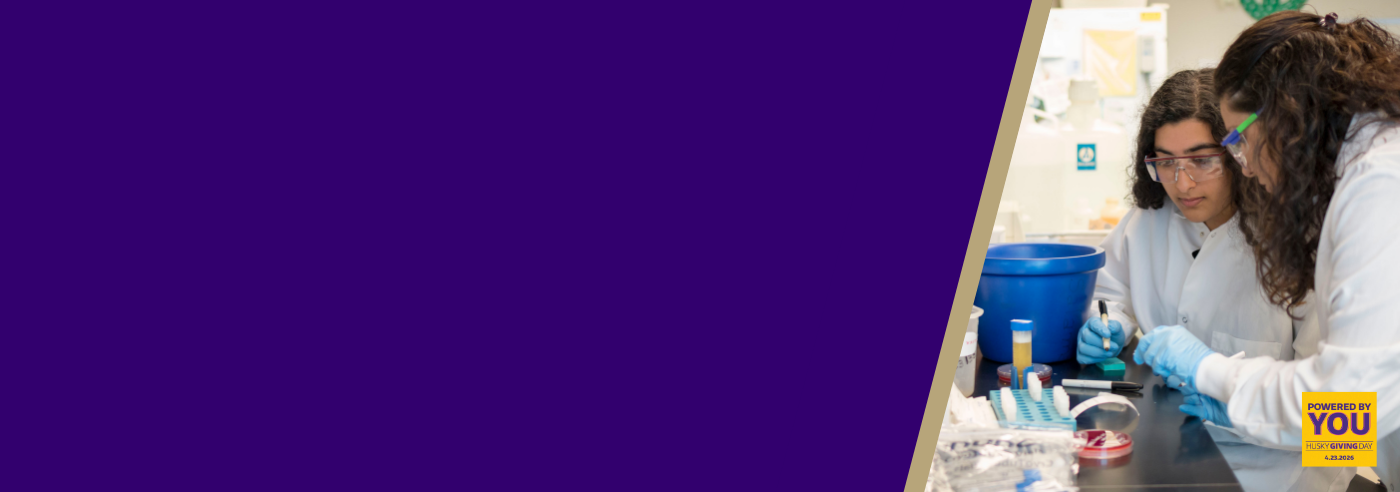 Two women in lab coats in a lab.