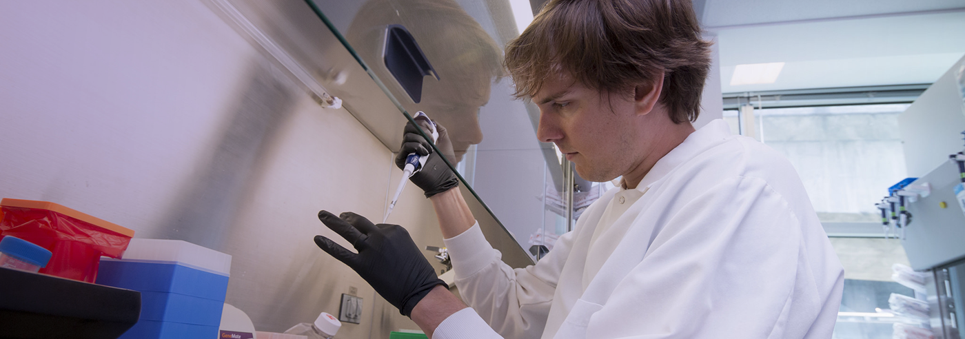 Photo of Pathobiology student using a pipet