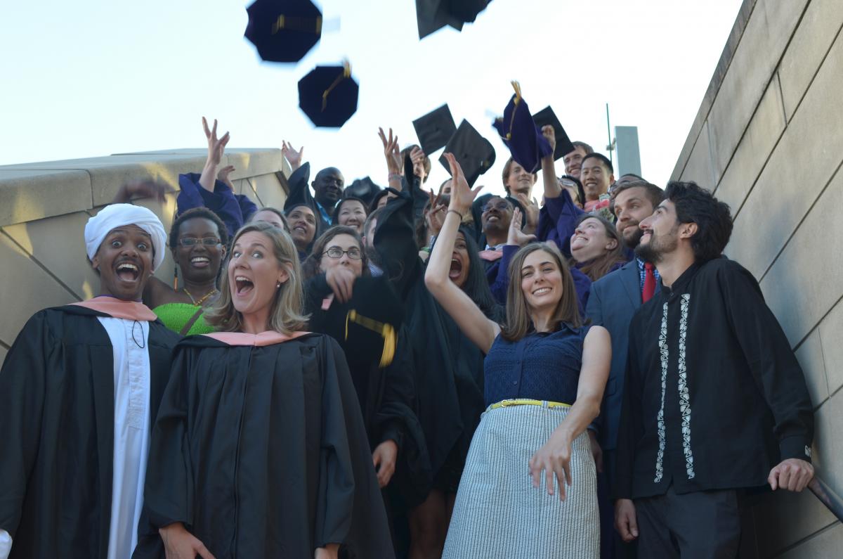 photo of 2015 graduates celebrating and throwing hats