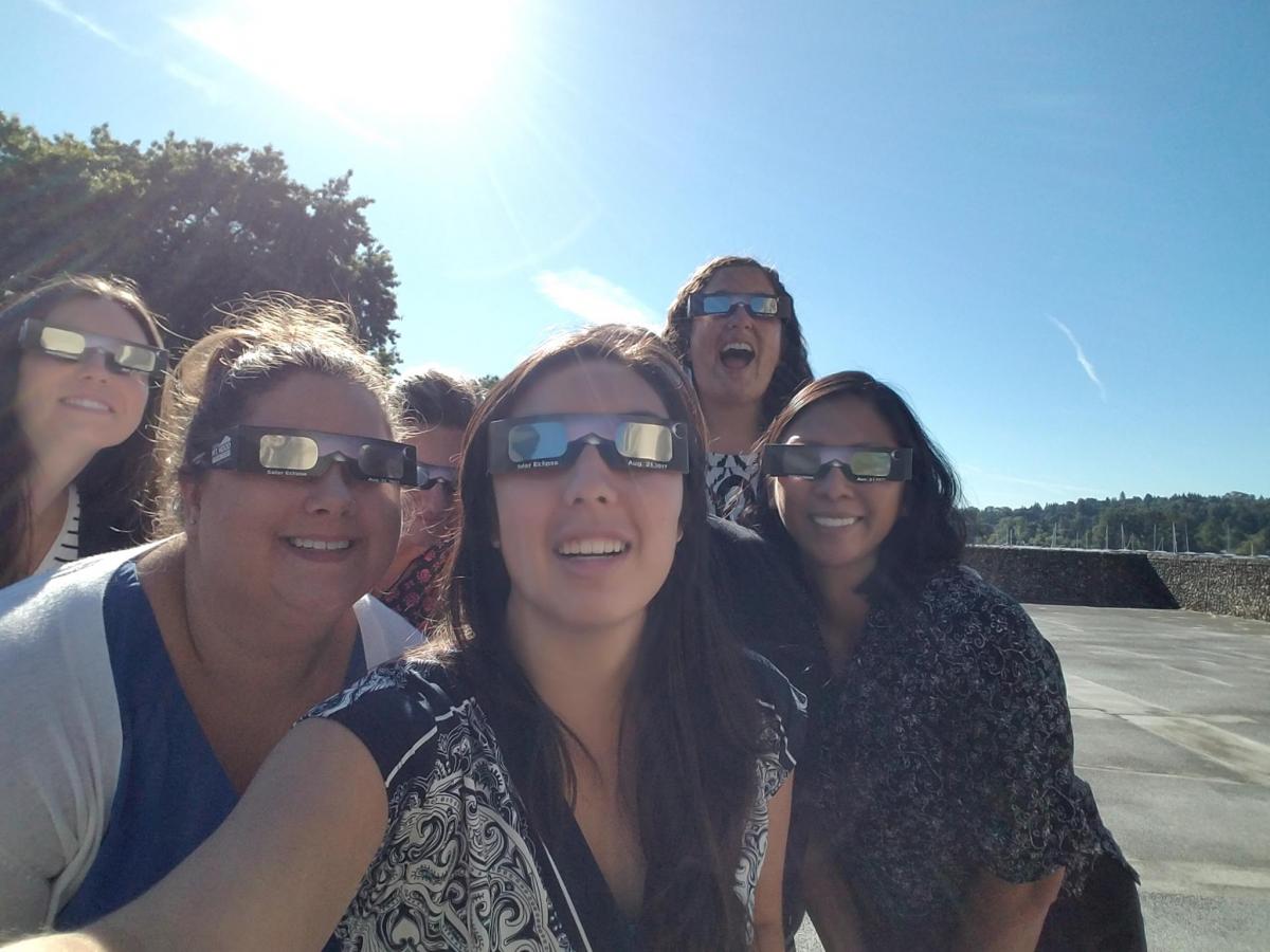 Staff watch the eclipse from Harris Hydraulics building in Seattle