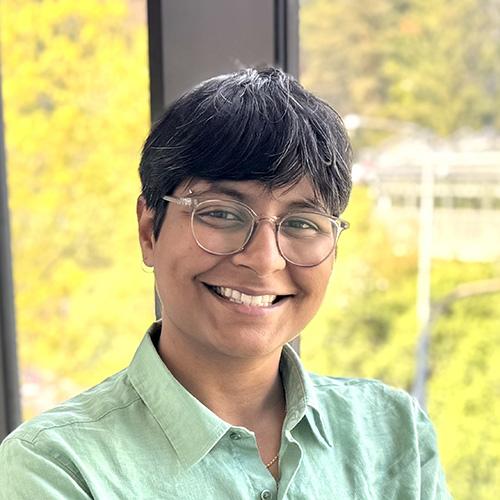Headshot of Mariyam Sibghatullah smiling in professional attire.