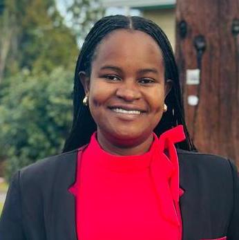 Headshot of Faraja Mgaya smiling in professional attire.