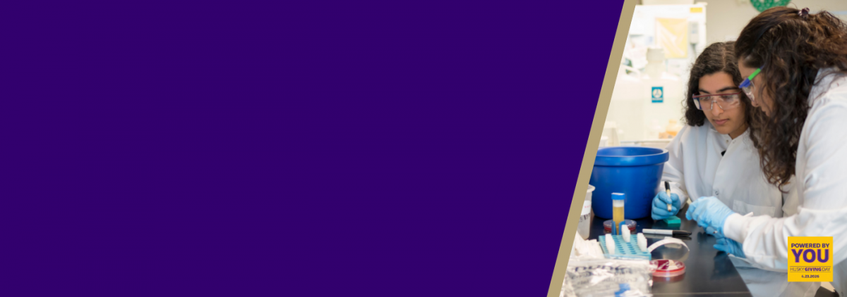 Two women in lab coats in a lab.