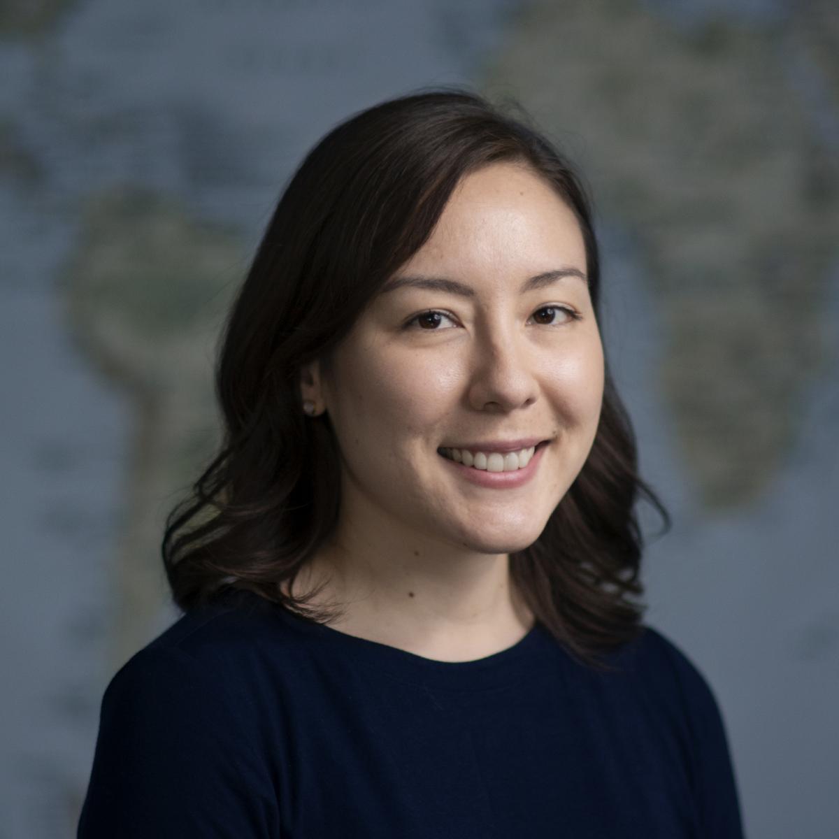 Profile photo of Stephanie Edlund-Cho in front of world map