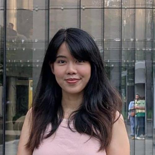 Headshot of Htoo Mar Lar wearing pink outside a windowed building.