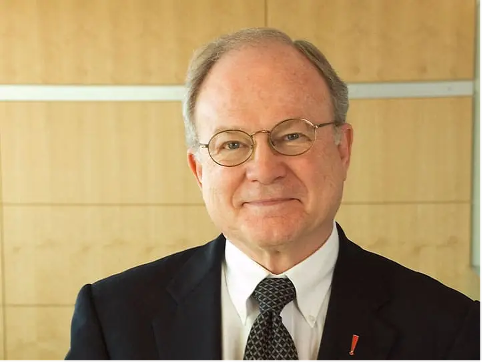 King, wearing a tuxedo, smiles at the camera. 