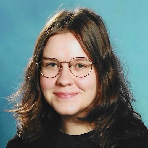 Headshot of Maggie Venberg smiling in professional attire.