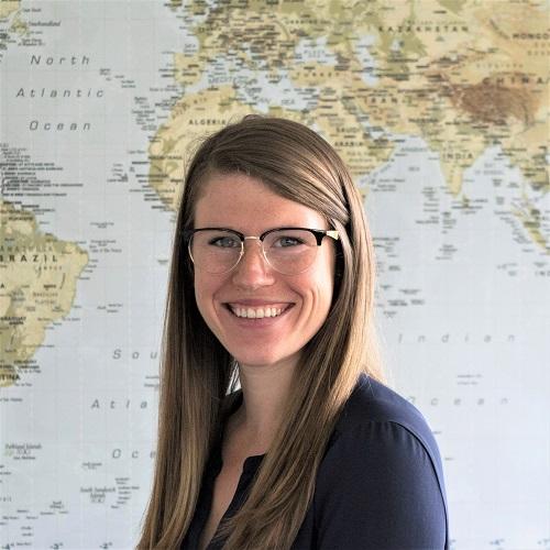 Profile photo of Tessa Concepcion in front of a world map