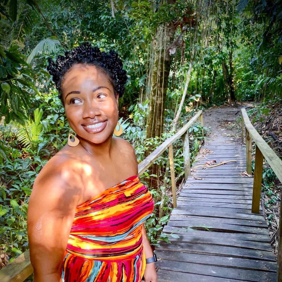 Tina standing in the jungle.
