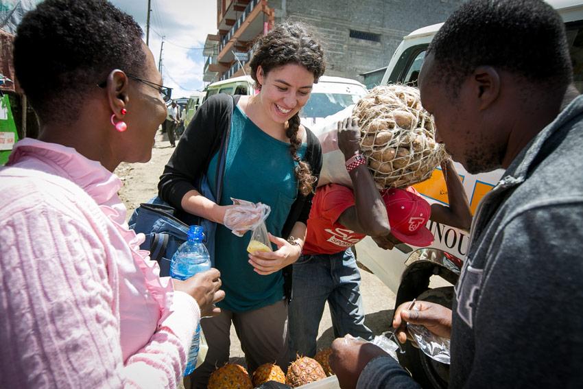 Photo of Zoe picking out pineapples at Market