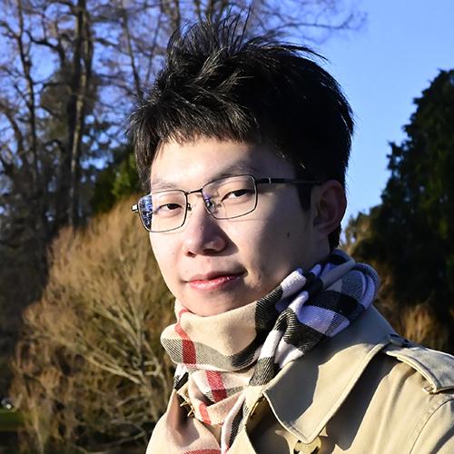 Headshot of Yixuan Wang smiling outside with a scarf and jacket.