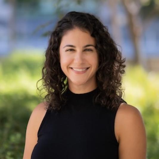 Headshot of Jennifer Velloza wearing professional attire outside.